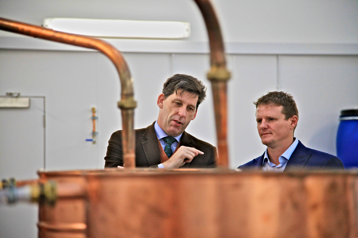 People at stills in the gin manfacturing area, Orkney Distillery